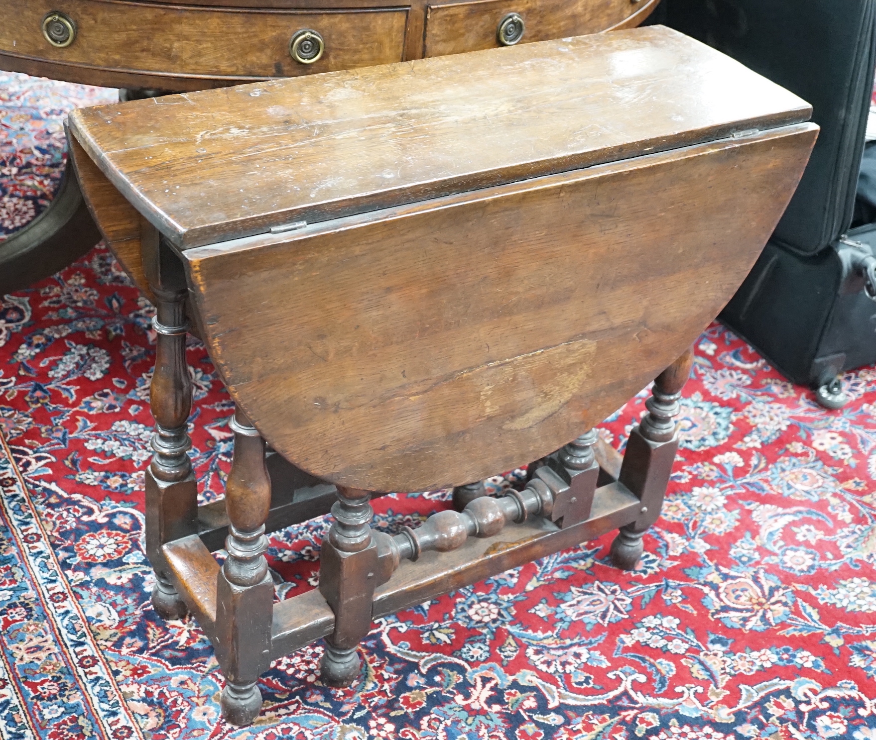 A small 18th century style oak gateleg table, width 76cm, depth 28cm, height 67cm